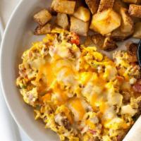Migas · Vegetarian. Eggs, corn chips, onions, serrano, and tomatoes all scrambled and topped with ch...