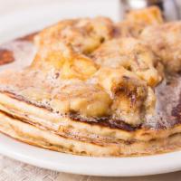 Banana Cognac Pancakes · Two buttermilk pancakes topped with roasted cognac bananas and 100% pure organic maple syrup.
