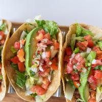 Impossible™ Tacos · Vegan, vegetarian. Three tacos with plant-based Impossible™ meat, salsa, iceberg lettuce, av...