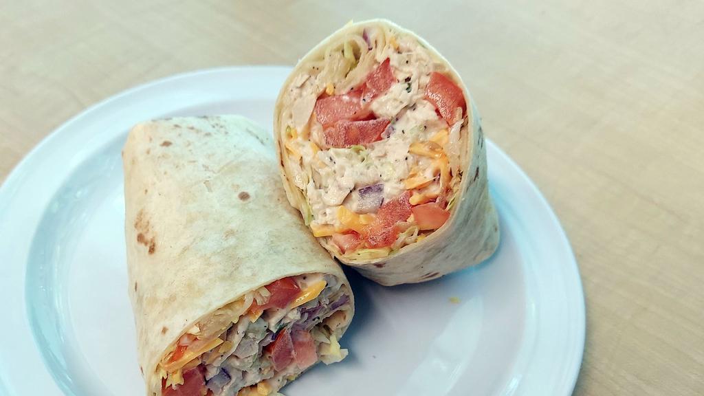 Chicken Salad Wrap · Chicken salad, lettuce, tomato, onions, and cheddar cheese on tortilla wrap.