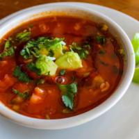 Caldo Tlalpeno Soup · Gluten free. Tomato broth, shredded chicken, rice, tomato, cilantro, onions, chipotle & avoc...