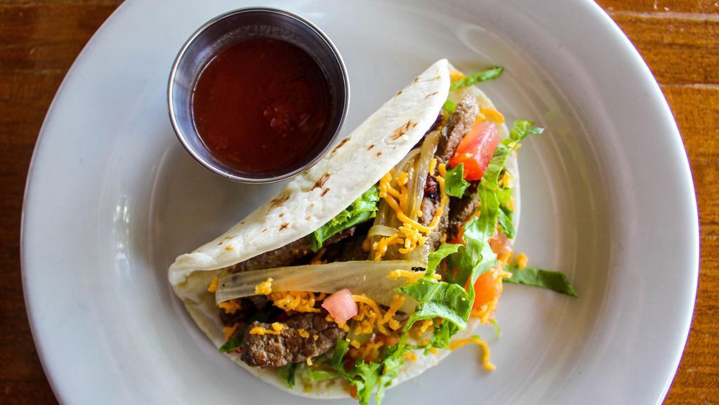 Steak Tacos · Marinated beef tips in a mild or spicy Mexicana sauce of roasted tomato, onion, cliantro & jalapeño served with a side of spicy guacamole-tomatillo sauce