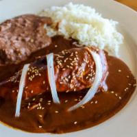 Chicken Mole · Chicken breast covered in traditional mole sauce prepared with dried peppers, spices, nuts &...