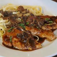 Chicken Marsala · Chicken medallions sautéed with mushrooms in a sweet Marsala cream sauce. Served over spaghe...