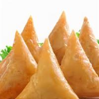 2-Meat Samosa · Two-fried pastry stuffed with green peas, potato, onion, and spices.