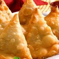 Vegetable Samosa · Fried pastry stuffed with green peas, potato, onion, and spices.