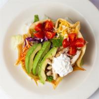 Taco Salad · Flour tortilla shell filled with romaine lettuce, avocado, cherry tomatoes, red onions, sour...
