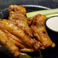 12 Classic Wings · Golden plump fresh chicken wings fried naked to a crispy golden brown and dripping in your f...