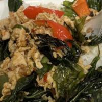 Koong Kai Kra Praw · Ground chicken and shrimp sautéed with chili paste, bell peppers topped with crispy basil le...
