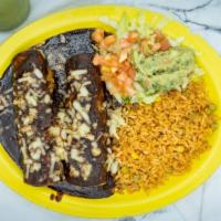 Enchiladas Poblanas · Three chicken enchiladas topped with mole poblano sauce. Served with rice and guacamole salad.