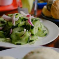 Cucumber Salad · Crisp and tangy Cucumber salad with red onions.

GF, V, VV