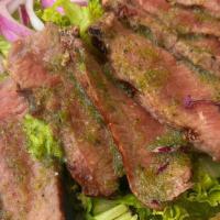 Soi Steak Salad · A summer salad, topped with grilled ribeye steak, and served with a side of sour & spicy cil...