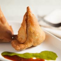 Samosa (2) · Deep-fried pastry triangles stuffed with spiced potatoes and green peas (two per order).
