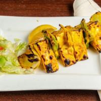 Paneer Tikka · Delicious homemade cheese cubes, green pepper, and onions marinated overnight with spices, c...