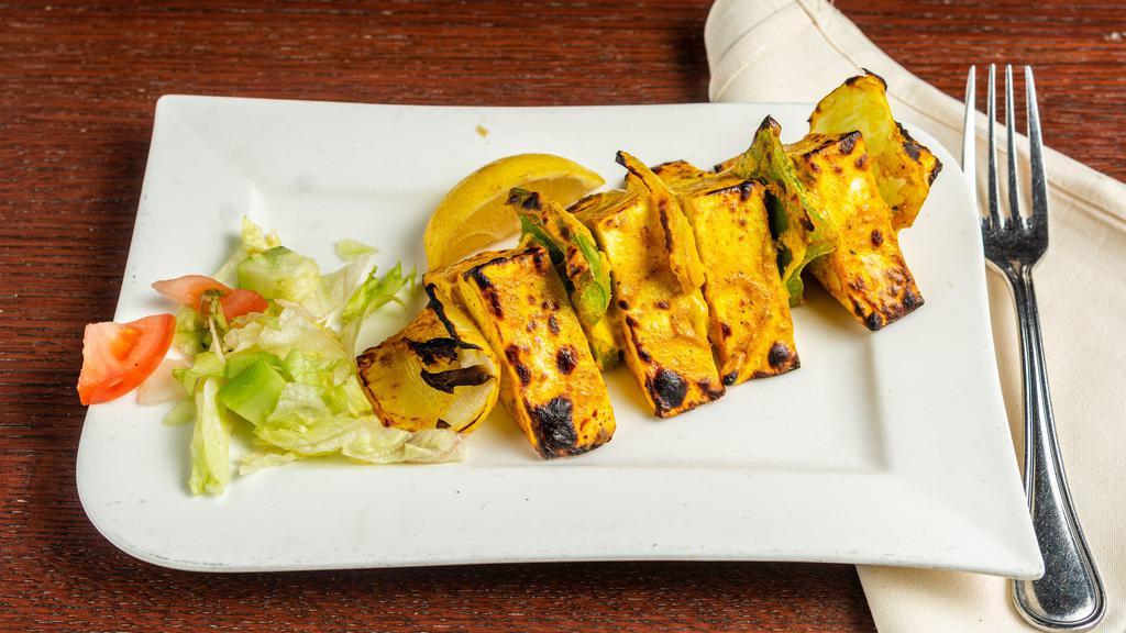 Paneer Tikka · Delicious homemade cheese cubes, green pepper, and onions marinated overnight with spices, cooked in the tandoor.