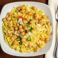 Bhelpuri · A tangy mélange of puffed riced crisps, lentils, and vermicelli tossed in chutney with chick...