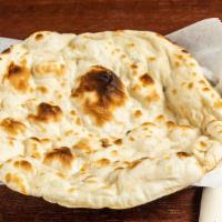 Naan · Leavened bread baked in flaming charcoal clay oven made with enriched white flour.
