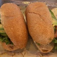 Avocado Sandwich · Bread, cheese, avocado, lettuce, tomato, cucumber, salt, onion, pepper, fresh lemon, and may...