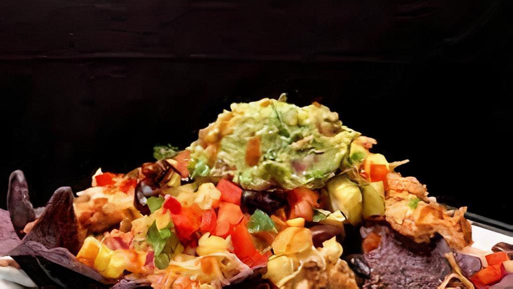 Maui Sesame Soy Nachos · Crispy nachos topped with choice of protein, sesame soy sauce, avocado, green onion, and furikake.