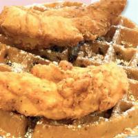 Connies Chocolate Chip Waffle With Chicken Breast Tenders · Two chicken breast tenders and a chocolate chip Belgian waffle with maple syrup.
