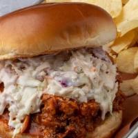 Buffalo Pulled Chicken Sandwich · Our Pulled Chicken topped with Buffalo Sauce and our Blue Cheese Slaw. Served with potato ch...