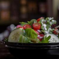 Garden Salad · Fresh mix of greens with grape tomatoes, cucumbers and red onions. Served with cornbread. GF...