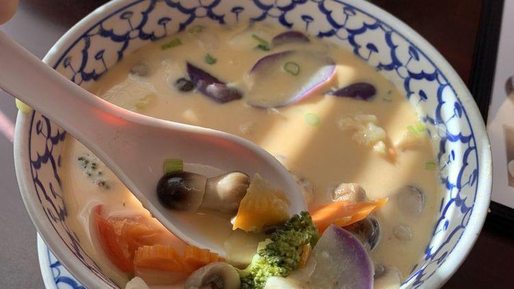 Tom Kha · Vegan. Hot and sour coconut milk soup with lemongrass, galangal roots, kaffir leaves, mushrooms, onions, and tomatoes.