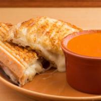 Grilled Cheese & Tomato Soup · Creamy fontina cheese grilled on Parmesan crusted sourdough with tomato soup.