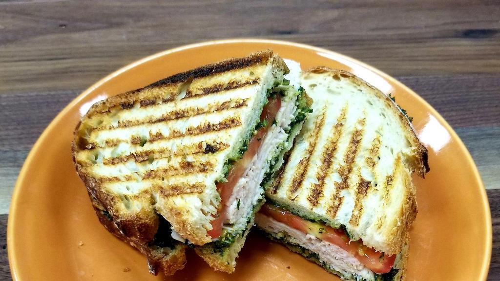 Turkey Pesto · Turkey, sliced tomato and basil/ garlic/ pine nut pesto on sourdough white bread. Add a cup of soup or baby greens salad for an additional charge.