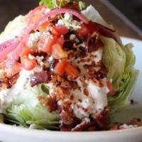 Iceberg Wedge · applewood smoked bacon, tomato, pickled red onion, blue cheese crumbles, creamy blue cheese ...