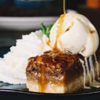 Orange Bourbon Pecan Bar · pecan pie on top of a shortbread cookie crust topped with caramel sauce and french vanilla b...