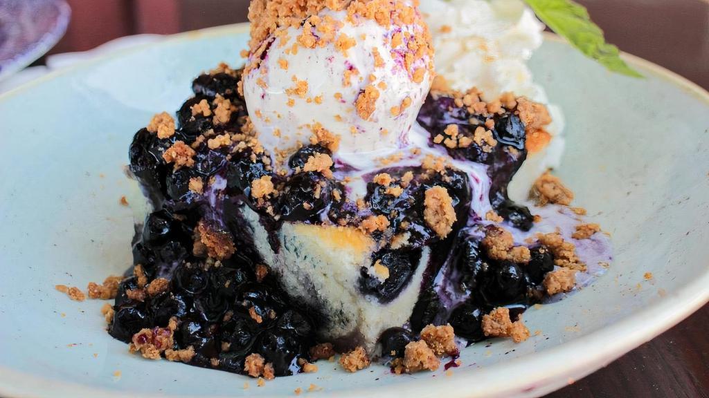 Blueberry Biscuit Cobbler · served with french vanilla bean ice cream, warm lemon blueberry sauce and an oatmeal crumb topping