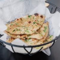 Garlic Naan · Freshly baked white bread topped with fresh garlic, cilantro, and butter.
