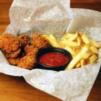 Chicken Nuggets · All white meat chicken nuggets served in a basket with fries and ketchup.
