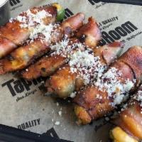 Jalapeño Poppers · Bacon wrapped jalapeños stuffed with cheddar jack.