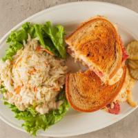 Classic Grilled Reuben With Choice Of Side · Corned beef, Swiss cheese, 1000 island dressing, and sauerkraut on marbled rye.