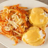 Classic Eggs Benedict Served With Hash Browns · Canadian bacon, poached eggs, hollandaise on an English muffin.