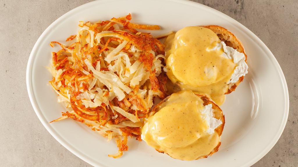 Classic Eggs Benedict Served With Hash Browns · Canadian bacon, poached eggs, hollandaise on an English muffin.