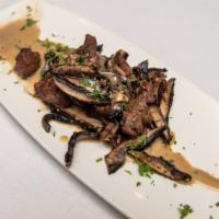 Grilled Portabella Mushrooms · Marinated then grilled and served with trattoria zip sauce. Add beef tips for an additional ...
