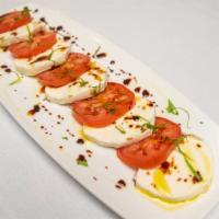 Traditional Caprese Salad · Vine ripened tomatoes, imported fresh mozzarella, basil and extra virgin olive oil, drizzled...
