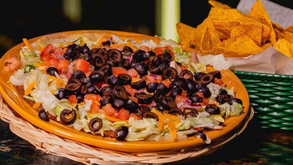 7 Layer Dip · Beans, queso, jalapeño cream cheese, pico de gallo, olives, lettuce, and cheese.