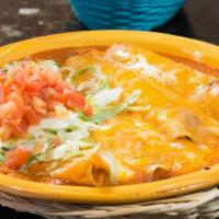 Enchilada Plate · Two ground beef and two cheese enchiladas topped with lettuce, tomato, gravy, and cheese.