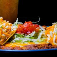 Taco Plate · Two hard shell beef tacos topped with lettuce, tomato, and cheese served with  rice and beans.