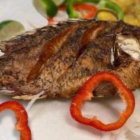 Pescado Frito · Fresh fried whole tilapia topped with sauteed bell peppers & onions; served with white rice,...