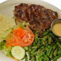 Lomo De Res A La Parrilla · 10 oz Angus Center-Cut Beef Ribeye: served with salad, mashed potatoes, & green plantains