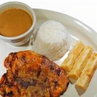 Chuleta A La Parrilla · Grilled porkchops marinated in our special seasoning; served with white rice, red beans, & f...