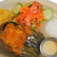 Tamal Valluno · Cooked cornmeal stuffed with pork, beef, chicken & vegetables. Wraped in plantains leaves, s...