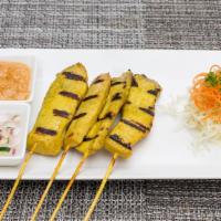 Satay · Grilled tender strips of marinated chicken on skewers, served with a side of peanut sauce an...