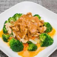Thai Rama · Your choices of meat sauteed in yellow curry sauce, topped with peanut sauce, served on a be...