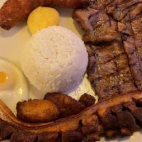 Plato Montañero · Beef, pork, chicken or ground beef (6 oz) with rice, beans, chorizo, fried pork rinds, sweet...